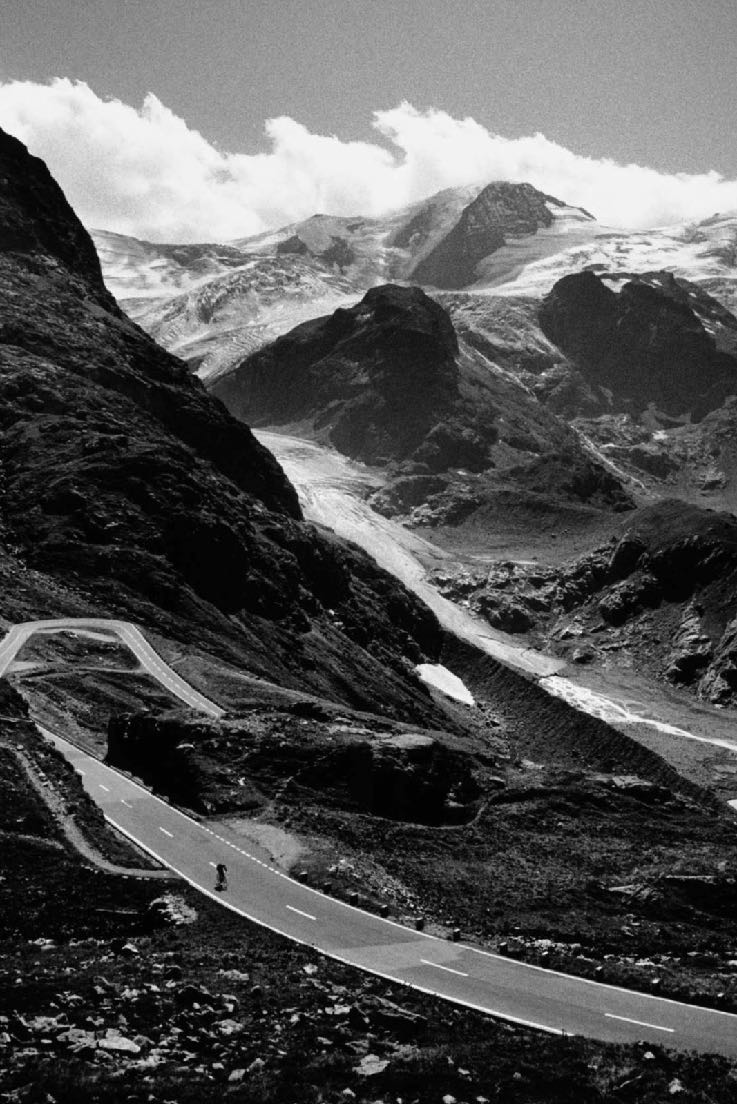 Lone cyclist on alpine switchback